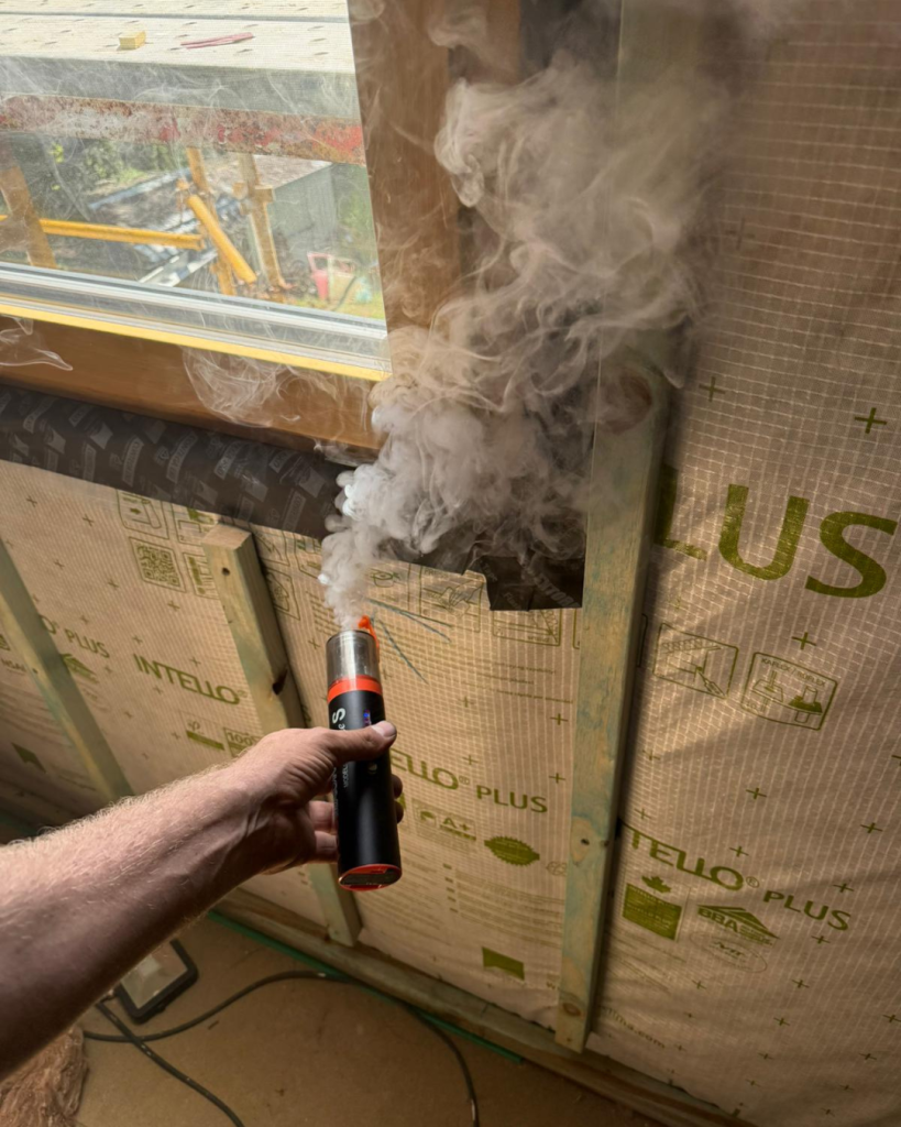 Smoke pencil used to locate air leakage during a blower-door test