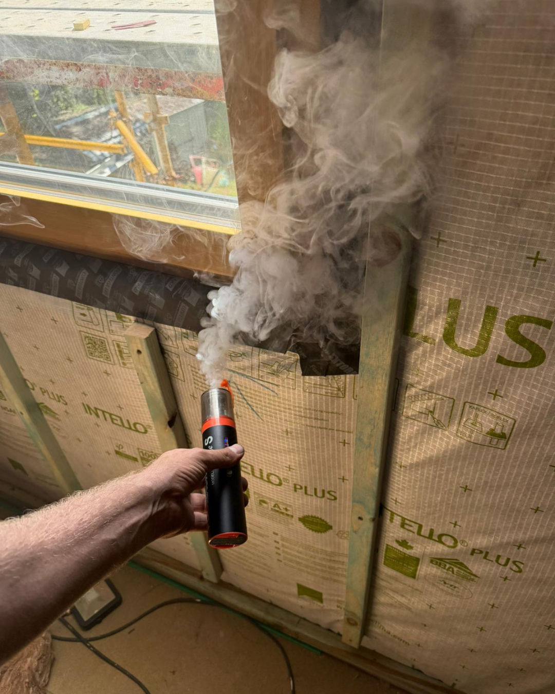 Smoke pencil used to locate air leakage during a blower-door test